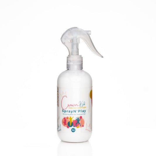 A spray bottle labeled 'Crown Kid's Spray N' Play' designed for children's hair care.